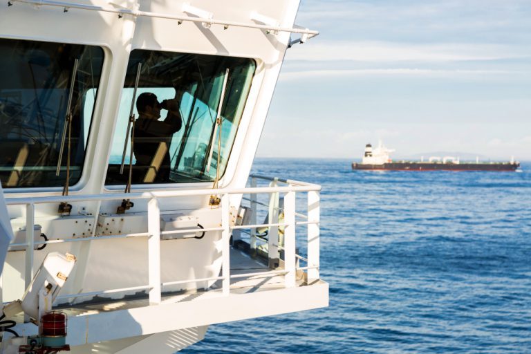 seafarer-using-binoculars-on-ship-bridge